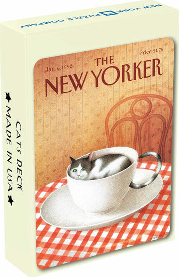 A whimsical deck of playing cards featuring a playful illustration of a cat nestled in a teacup. The packaging showcases a vintage design reminiscent of a New Yorker magazine cover, with a checkered tablecloth backdrop that adds to the charm.