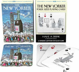 A deck of Have A Drink Playing Cards by New York Puzzle Company. The packaging features colorful artwork of a champagne bottle and cartoon characters celebrating. The cards display uniquely illustrated cartoons, with a poker-sized format highlighting illustrations related to drinking and humor.
