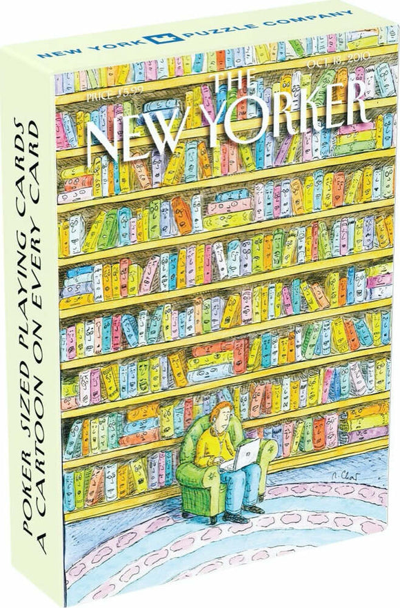 The Book Lover Playing Cards by New York Puzzle Company features a whimsical illustration of a person sitting in a green chair with a laptop, surrounded by colorful bookshelves filled with various books. Each playing card showcases a different cartoon, celebrating the joy of reading.