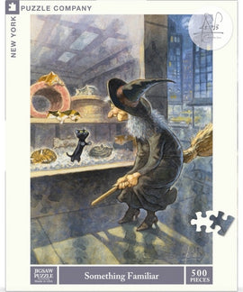 A whimsical 500-piece jigsaw puzzle titled 'Something Familiar' by New York Puzzle Company, featuring a witch with a broomstick observing playful cats in a pet shop window.