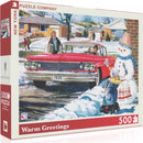 A 500-piece jigsaw puzzle titled 'Warm Greetings' by New York Puzzle Company. The box features a nostalgic winter scene with a vintage red car parked in front of houses, children playing in the snow, and a cheerful snowman. The artwork captures a warm, festive atmosphere reminiscent of classic holiday greetings.