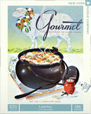 A colorful illustration of a cozy kitchen scene featuring a large black pot of lamb stew, garnished with vegetables. The background includes a whimsical sheep with a floral wreath. The cover design is from the May 1946 issue of Gourmet magazine, highlighting the artwork of Henry Stuhlman. This 500-piece jigsaw puzzle captures a nostalgic culinary theme, perfect for puzzle enthusiasts and food lovers.