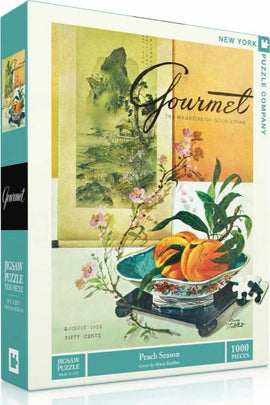 Peach Season Gourmet Puzzle, a 1000-piece jigsaw puzzle by New York Puzzle Company featuring a vintage artwork of peaches in a bowl accompanied by delicate pink flowers and a scenic landscape background, packaged elegantly in a colorful box.