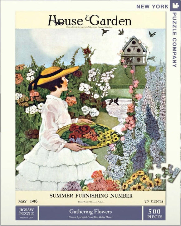 A vintage jigsaw puzzle featuring a woman in a white dress and yellow hat, gathering colorful flowers in a lush garden. The scene includes vibrant floral arrangements and a decorative birdhouse in a picturesque garden setting, inspired by a vintage magazine cover from May 1916.
