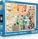 The Beachcomber Collection puzzle box featuring a vibrant assortment of beachcombed objects, including colorful bottles, shells, driftwood, and various ocean finds arranged artistically on a neutral background. The puzzle consists of 1000 pieces and is made by New York Puzzle Company.