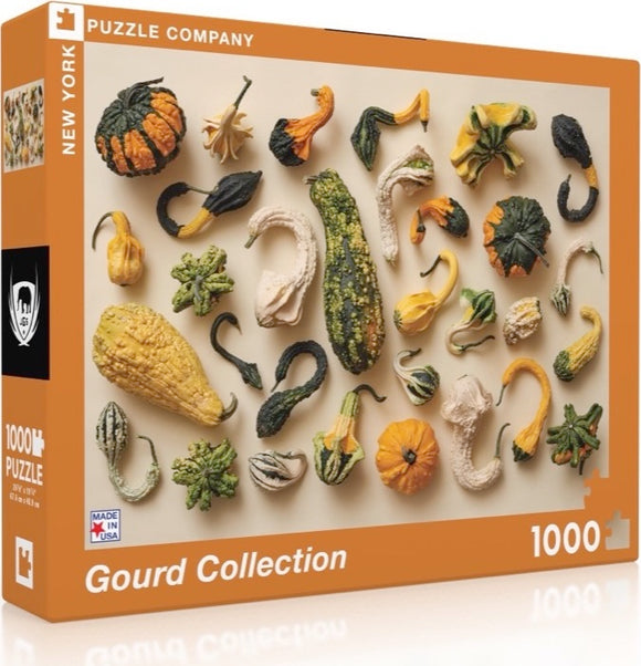 A colorful jigsaw puzzle box featuring a Gourd Collection. The box showcases various types of gourds, including squash and pumpkins, artistically arranged. The puzzle contains 1000 pieces and is made in the USA. The packaging highlights the distinctive shapes and textures of the gourds, appealing to nature and puzzle enthusiasts alike.