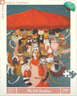 The Cat Countess Jigsaw Puzzle featuring a whimsical painting of a woman holding a red umbrella surrounded by multiple adorable cats in various colors and patterns, with a blue background and rain falling. The puzzle consists of 1000 pieces, perfect for cat lovers and puzzle enthusiasts.