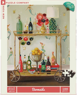 Bar Maids Janet Hill jigsaw puzzle by New York Puzzle Company, featuring a vibrant illustration of a bar cart adorned with colorful bottles, a silver bowl of lemons, and playful mermaids in the background. The puzzle contains 500 pieces and showcases an artistic design perfect for puzzle enthusiasts and art lovers alike.