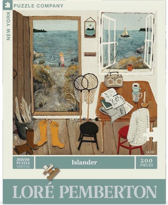 Islander jigsaw puzzle by New York Puzzle Company featuring a cozy scene of a seaside home. The illustration depicts an open door with a child in striped clothes standing by the water, surrounded by fishing nets, boots, a table with books, a candle, and a scenic view of boats on the water. The puzzle contains 500 pieces and is designed by Loré Pemberton.