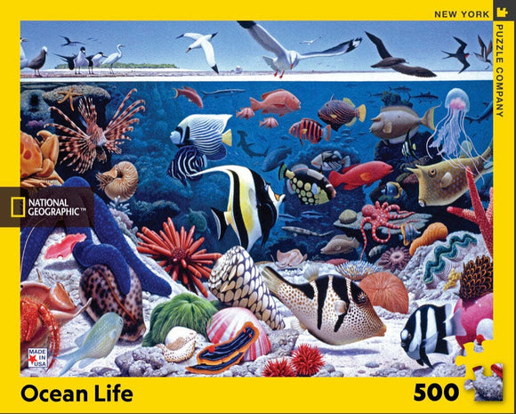 A vibrant jigsaw puzzle featuring an underwater scene filled with diverse marine life, including colorful fish, corals, jellyfish, and birds above the water's surface. The puzzle has 500 pieces and is created by New York Puzzle Company in collaboration with National Geographic.