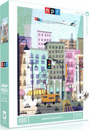 NPR Sound Community Jigsaw Puzzle featuring a colorful urban scene with buildings, trees, and a street filled with activity. The puzzle comes in a 1000-piece format by New York Puzzle Company, showcasing a vibrant depiction of city life.