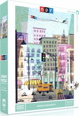 NPR Sound Community Jigsaw Puzzle featuring a colorful urban scene with buildings, trees, and a street filled with activity. The puzzle comes in a 1000-piece format by New York Puzzle Company, showcasing a vibrant depiction of city life.