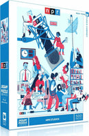 NPR Studios jigsaw puzzle by New York Puzzle Company featuring a vibrant illustration of a radio studio. The artwork depicts diverse characters engaged in various activities related to broadcasting, with bright colors and intricate details. The puzzle consists of 500 pieces and comes in a sturdy, decorative box.