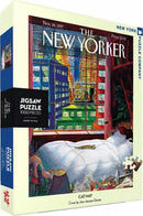 Box of the Cat Nap Jigsaw Puzzle (1000 pieces) by New York Puzzle Company featuring a whimsical illustration by Jean-Jacques Sempé, showcasing a cozy scene with a comfortable bed and a playful cat. The artwork captures the essence of relaxation and warmth, perfect for puzzle enthusiasts.
