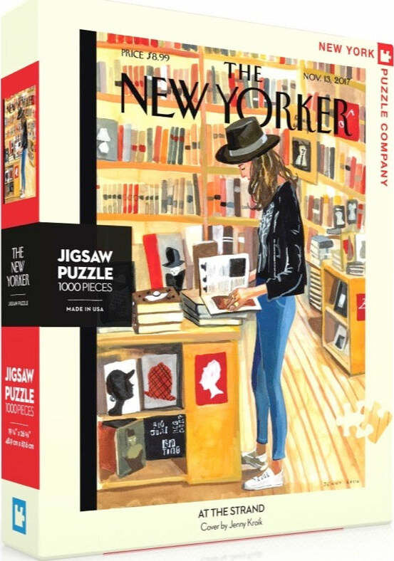 At the Strand 1000-piece jigsaw puzzle from New York Puzzle Company, featuring an illustration of a woman browsing books in a cozy bookstore. The vibrant artwork captures the ambiance of a literary haven, perfect for puzzle enthusiasts and New Yorker fans. The box displays the iconic New Yorker logo and highlights the puzzle's features.