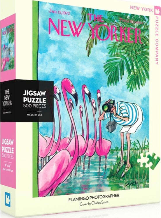 Flamingo Photographer jigsaw puzzle featuring a vibrant illustration of pink flamingos and a person taking a photo, designed by Charles Saxon, produced by New York Puzzle Company. The puzzle contains 500 pieces and is packaged in a colorful box.