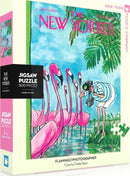 Flamingo Photographer jigsaw puzzle featuring a vibrant illustration of pink flamingos and a person taking a photo, designed by Charles Saxon, produced by New York Puzzle Company. The puzzle contains 500 pieces and is packaged in a colorful box.