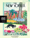A scenic jigsaw puzzle featuring a black cat walking through a vibrant garden, surrounded by colorful flowers and greenery. The image is a recreation of the June 18, 1960, cover of The New Yorker, illustrated by William Steig. The puzzle consists of 1000 pieces and is made in the USA.