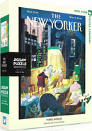 The Three Amigos Puzzle box showcases a jigsaw puzzle featuring a vibrant illustration from The New Yorker. The artwork, created by Jean-Jacques Sempé, depicts three figures playing guitars in a cozy room, filled with warm colors and a charming New York backdrop. The box is designed with vibrant colors and includes text indicating it contains 1000 pieces.