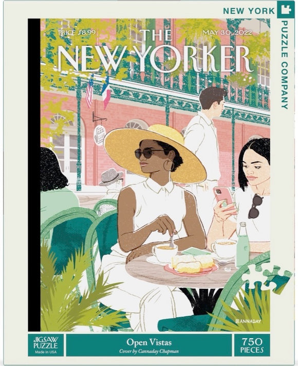 The Open Visits jigsaw puzzle by New York Puzzle Company features an illustration of a sunny café scene with a stylish woman in a wide-brimmed hat enjoying tea and pastries at a table. In the background, other patrons are seen, creating a lively atmosphere. The design is colorful and reminiscent of the New Yorker magazine art style, comprising 750 pieces for an engaging puzzle experience.