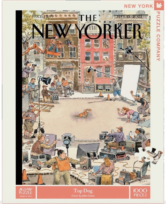 The Top Dog jigsaw puzzle features an illustration from The New Yorker, depicting a bustling film set with crew members, equipment, and a playful dog in the center. Made by New York Puzzle Company, the artwork is vibrant and detailed, showcasing 1000 pieces that promise hours of engaging fun.