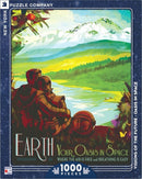 A colorful jigsaw puzzle featuring a vibrant landscape titled 'Your Oasis in Space'. The artwork depicts a serene couple sitting by a peaceful lake with mountains in the background, symbolizing harmony with nature. The puzzle has 1000 pieces and is produced by New York Puzzle Company.
