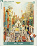 A colorful, bustling city scene featured on the jigsaw puzzle titled 'City Prayer' by New York Puzzle Company. The illustration shows a vibrant urban street filled with people, vehicles, and shop signs in various languages. The sun shines brightly overhead, illuminating the busy atmosphere and details of the city life. This jigsaw puzzle consists of 1000 pieces, offering a challenging and enjoyable experience for puzzle enthusiasts.