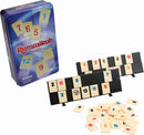 Rummikub Travel Tin game set, featuring a colorful tin with the Rummikub logo and number tiles spread out on a table. Includes two tile racks and numbered tiles in various colors. Perfect for travel and family fun.