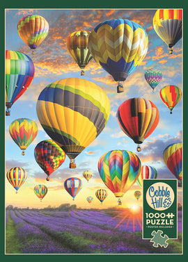 A colorful jigsaw puzzle featuring a stunning scene of numerous hot air balloons floating above a vibrant lavender field with a beautiful sunset in the background. The puzzle consists of 1000 pieces and includes a poster for reference. Made by Cobble Hill, this puzzle offers a delightful and engaging experience for puzzle enthusiasts.