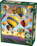 A vibrant jigsaw puzzle box featuring a scenic view of colorful hot air balloons floating in a blue sky during sunset. The puzzle contains 1000 pieces and includes a poster of the image.