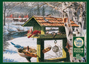 Backyard Banquet jigsaw puzzle by Cobble Hill featuring a serene winter scene. A bird feeder is shown with various birds perched on it, surrounded by snowy trees, a river, and red farmhouses in the background. The puzzle contains 1000 pieces and includes a poster.