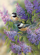 A beautifully illustrated jigsaw puzzle featuring two chickadees perched on lilac branches, surrounded by vibrant purple blooms, creating a serene and colorful nature scene.