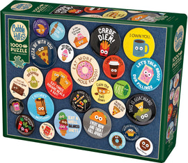 A Cobble Hill jigsaw puzzle featuring 1,000 colorful buttons with humorous slogans and cute cartoon designs. The puzzle showcases various playful messages like 'Carbe Diem', 'Pizza Be With You', and 'You Just Got Soft Served', ideal for puzzle enthusiasts and collectors. The box includes a poster of the completed puzzle image.