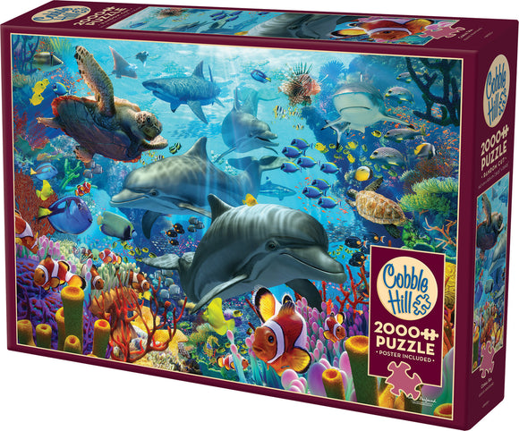 Coral Sea jigsaw puzzle by Cobble Hill featuring an underwater scene with dolphins, fish, and vibrant coral reefs. Includes a poster for reference. 2000+ pieces.