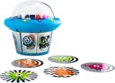 A colorful game called Match-A-Martian by PlayMonster. It features a UFO-shaped device with a clear dome on top and images of friendly aliens on its sides. Surrounding the UFO are circular cards with various alien designs and patterns, featuring bright colors like green, orange, pink, and black and white stripes. It is designed for fun and engaging gameplay.
