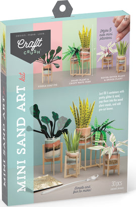 The Mini Sand Art Kit by Craft Crush includes materials to create five miniature planters. Each planter features vibrant, colorful sand and stylish decorations including fiddle-leaf fig, snake plant, and spider plant. The kit encourages creativity and hands-on crafting, suitable for ages 13 and up. Displayed items are arranged with plant stands and tools showcasing the finished look of the mini sand art.