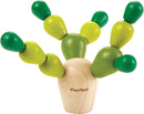 The Balancing Cactus Mini game from Plan Toys features a whimsical design with a base resembling a cactus pot, topped with vibrant wooden pegs in shades of green and yellow. These movable pieces allow for creative stacking and balance challenges, making it a fun and engaging game for children that promotes fine motor skills and coordination.