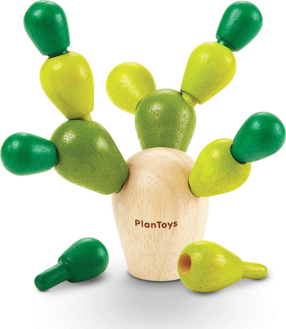 A Balancing Cactus Mini game by Plan Toys featuring a wooden cactus with colorful green and yellow pegs. The game encourages coordination and balance as players stack the pegs on the base. Perfect for developing fine motor skills and provides interactive fun for kids.