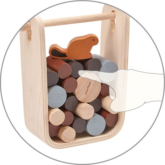 The Timber Tumble game by Plan Toys features a wooden carrying case filled with colorful cylindrical pieces. A playful beaver figure sits atop the pile, inviting children to engage in imaginative play and skill-building activities.