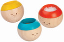The Sensory Tumbling Classic by Plan Toys features three colorful, round wooden balls with cheerful faces. Each ball has a playful top in red, yellow, and blue, designed to engage children in sensory play and enhance fine motor skills. The smooth wooden texture and vibrant colors invite interactive play, making it perfect for developing coordination and sensory awareness.