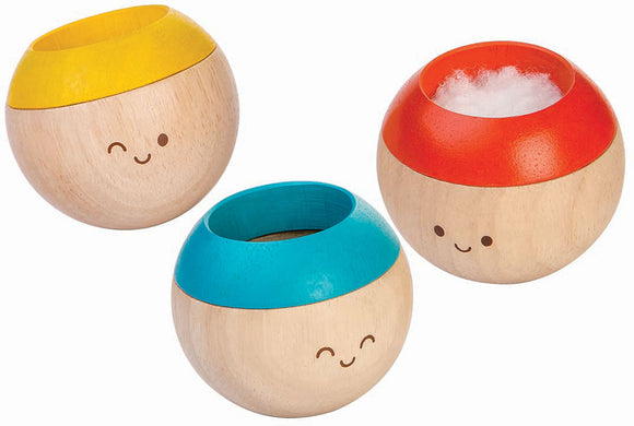 The Sensory Tumbling Classic by Plan Toys features three colorful, round wooden balls with cheerful faces. Each ball has a playful top in red, yellow, and blue, designed to engage children in sensory play and enhance fine motor skills. The smooth wooden texture and vibrant colors invite interactive play, making it perfect for developing coordination and sensory awareness.
