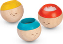 The Sensory Tumbling Classic game by Plan Toys features three colorful wooden balls with playful smiling faces. Each ball has a distinct color on the top—yellow, blue, and red—while their bodies have a natural wood finish, making them visually appealing and delightful for tactile engagement.