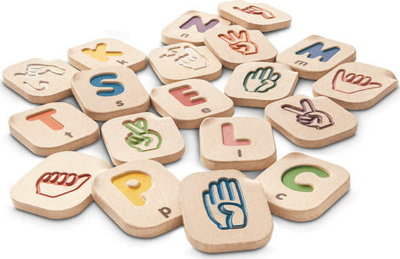Plan Toys Hand Sign A-Z Alphabet game featuring wooden pieces with engraved letters and hand sign illustrations. Colorful and educational, perfect for teaching sign language to children while promoting fine motor skills.