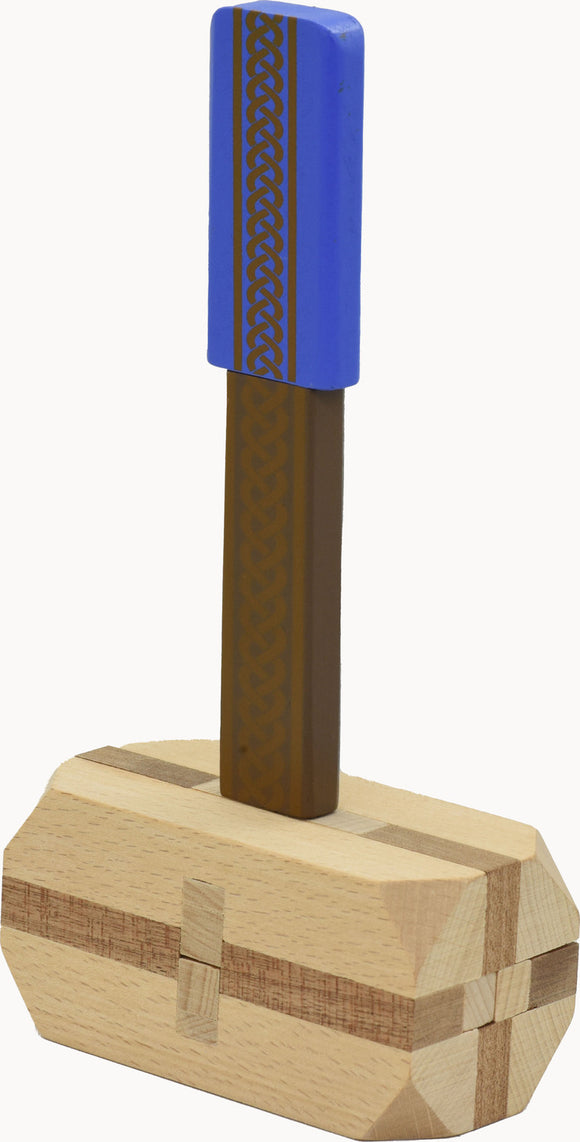 Thor's Hammer, a mechanical puzzle designed by Project Genius. The puzzle features a unique design with a blue top and an intricate patterned handle, crafted from wood. It offers an engaging challenge for puzzle enthusiasts and fans of Norse mythology, combining play and craftsmanship.