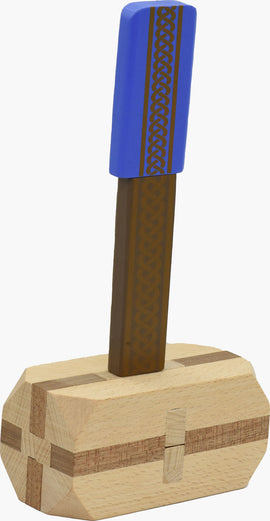 A mechanical puzzle designed like Thor's Hammer, featuring a vibrant blue handle adorned with intricate geometric patterns. The sturdy base is crafted from light and dark wood, showcasing elegant detailing. This visually striking piece is perfect for puzzle enthusiasts seeking a challenging and fun activity.
