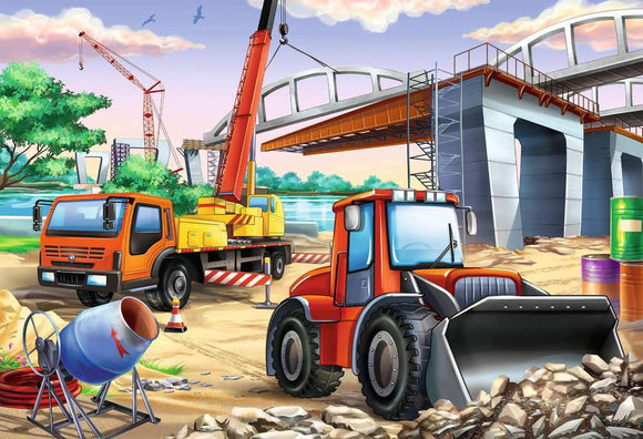 A colorful jigsaw puzzle featuring construction vehicles at a building site. The image showcases a bright orange truck, a red tractor, a cement mixer, and cranes, all surrounded by construction materials and a partially completed bridge, set against a vibrant landscape.