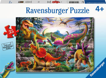 Ravensburger T-Rex Terror jigsaw puzzle featuring a vibrant scene filled with various dinosaurs in a lush prehistoric landscape. Ideal for children aged 4 and up, the puzzle consists of 35 large pieces showcasing colorful dinosaurs such as a T-Rex, Triceratops, and more, surrounded by tropical plants and a waterfall. Promotes learning and fun for young puzzle enthusiasts.