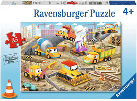 Colorful Ravensburger jigsaw puzzle titled 'Raise the Roof!'. The image features cheerful construction vehicles including a dump truck, excavator, cement mixer, and road roller, set in a busy construction site with barriers and buildings in the background. Suitable for children aged 4 and up, this puzzle has 35 pieces for engaging playtime.