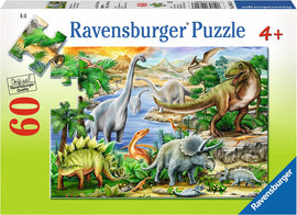 A Ravensburger jigsaw puzzle titled 'Prehistoric Life' featuring a vibrant and detailed illustration of various dinosaurs in a lush, prehistoric landscape. The scene includes a T-Rex, Triceratops, Brontosaurus, and other dinosaurs surrounded by greenery, mountains, and a serene body of water, designed for ages 4 and up with 60 pieces.