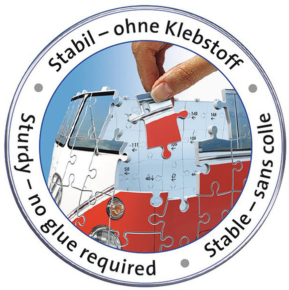 A close-up image of a Ravensburger jigsaw puzzle featuring a VW Bus T1. The image shows a hand inserting a puzzle piece into the bus structure. The circular border reads 'Stabil – ohne Klebstoff' in German and 'Sturdy – no glue required' in English, highlighting the ease of assembly. Colorful pieces with numbers are partially fitted together, demonstrating the vibrant design of the puzzle.